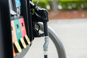 gas station fuel pump handle and fuel selection close up side view 